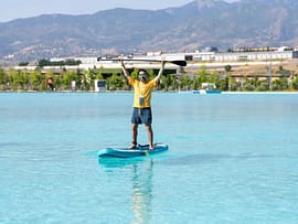 pexels-photo-32420318-32420318 Man paddleboarding on a turquoise lake with stunning mountain scenery in Kahramanmaraş.